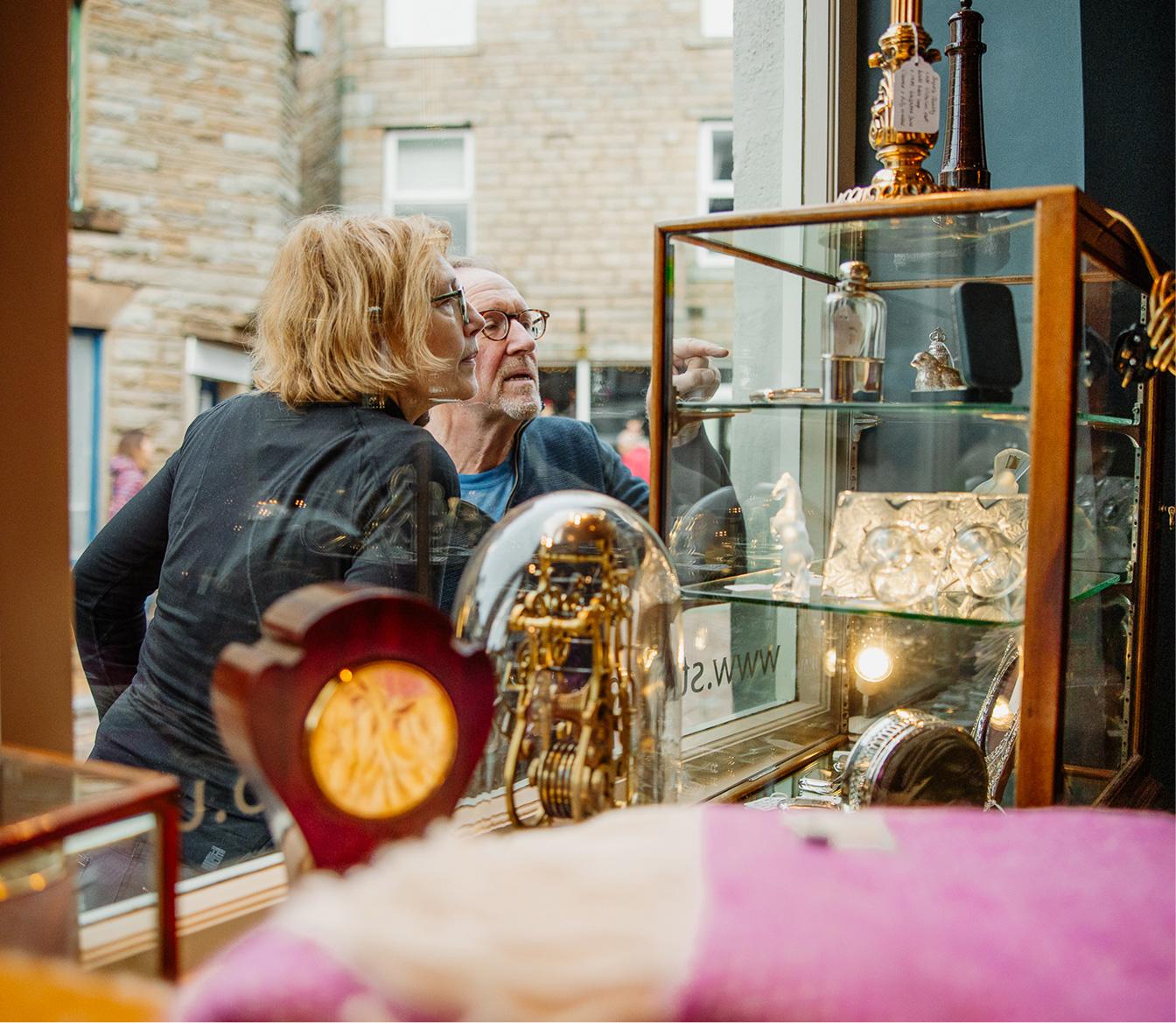 Two people looking through the shop window