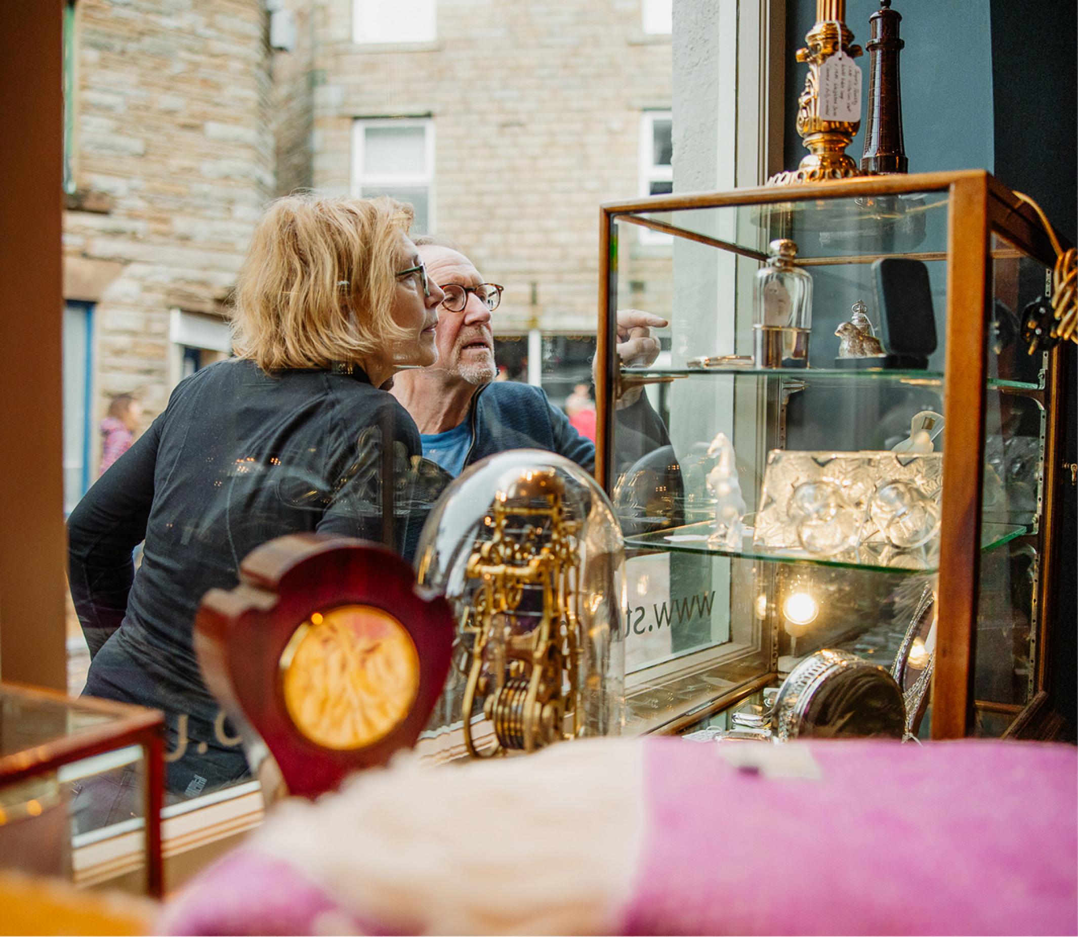 Two people looking through the shop window